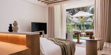 a bedroom with a television and a table