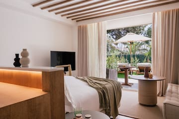 a bedroom with a television and a table