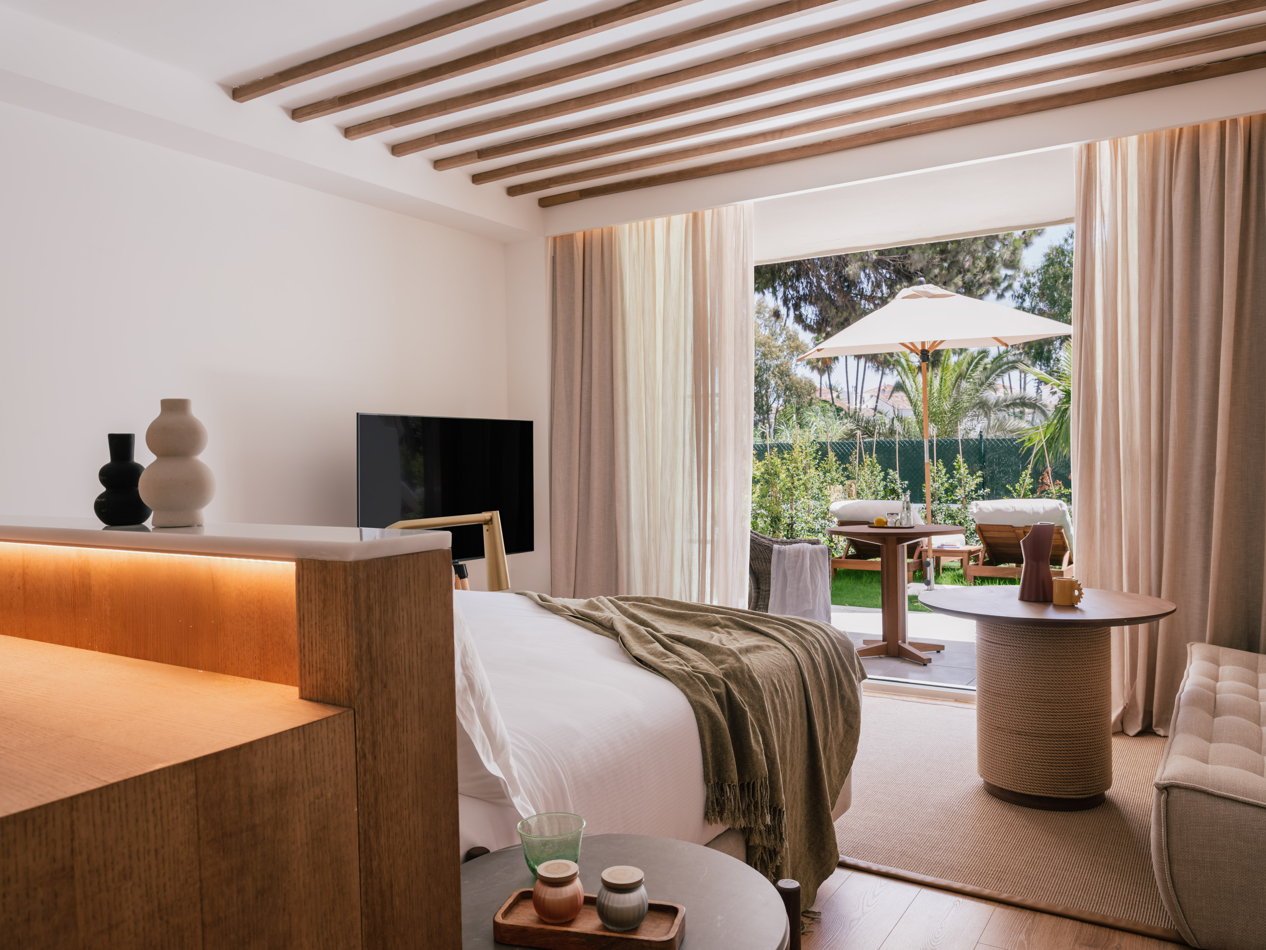 a bedroom with a television and a table