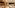 Hotel buffet with fresh bakery, cold cuts, cheeses, and modern wood design.