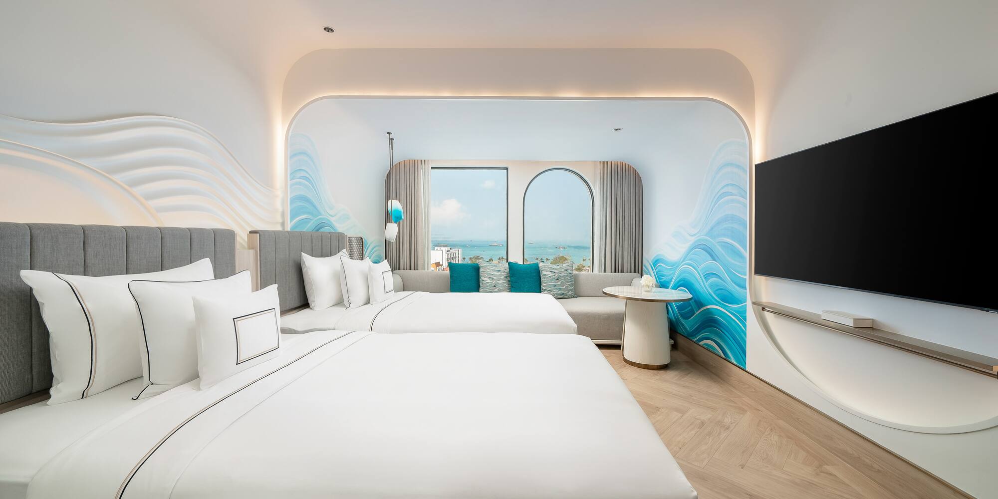 a room with two beds and a television