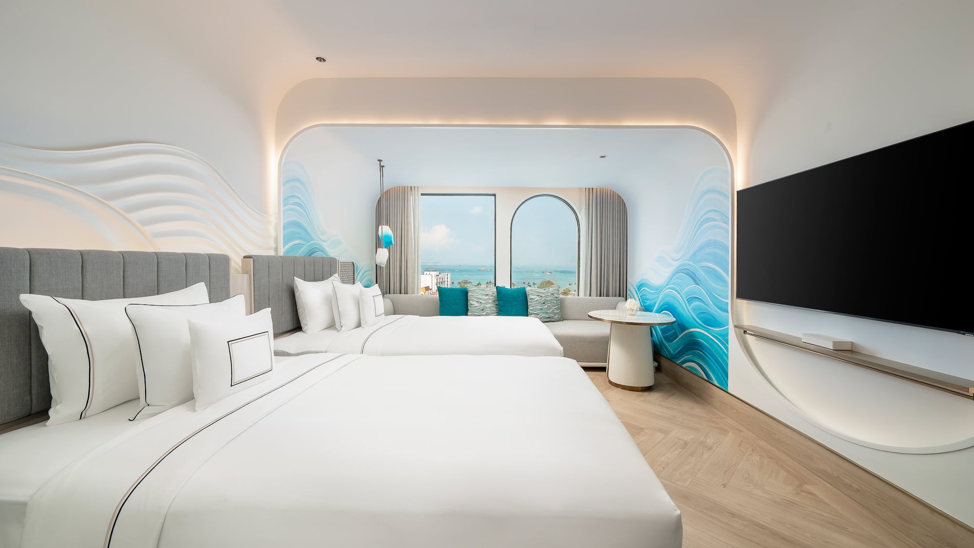 a room with two beds and a television