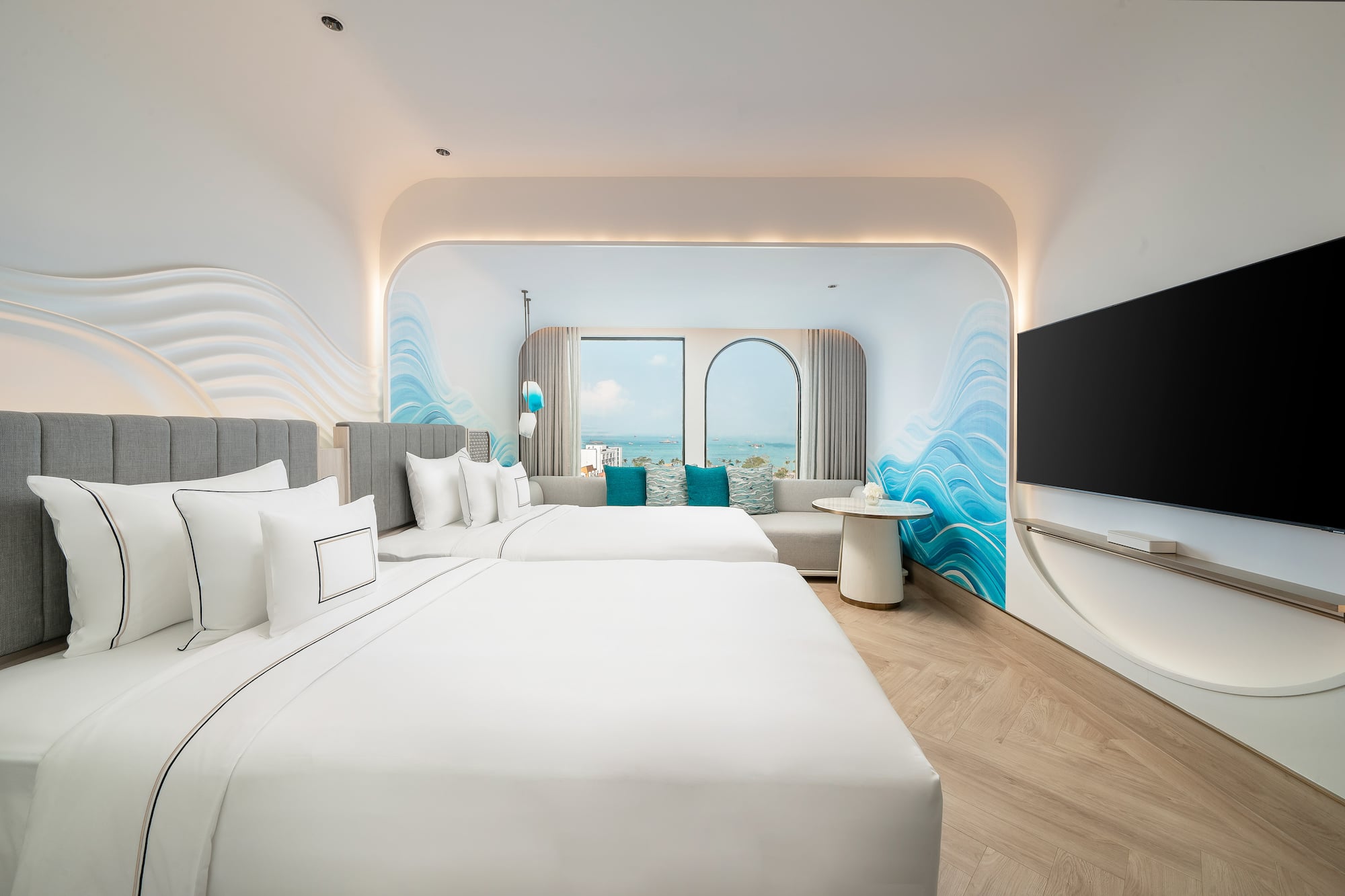 a room with two beds and a television