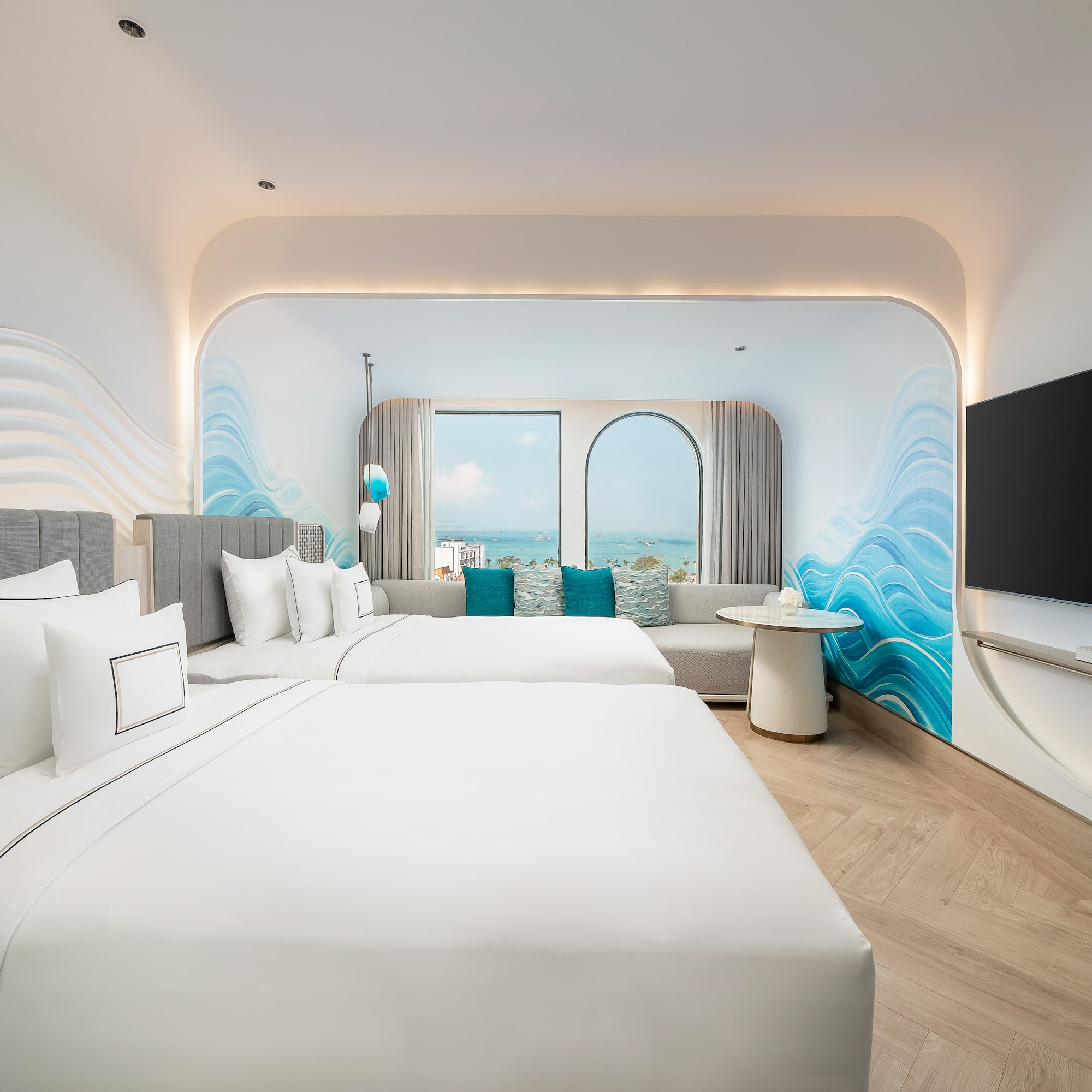 a room with two beds and a television