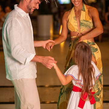 a man and woman holding hands and smiling