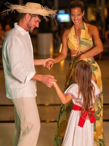 a man and woman holding hands and smiling