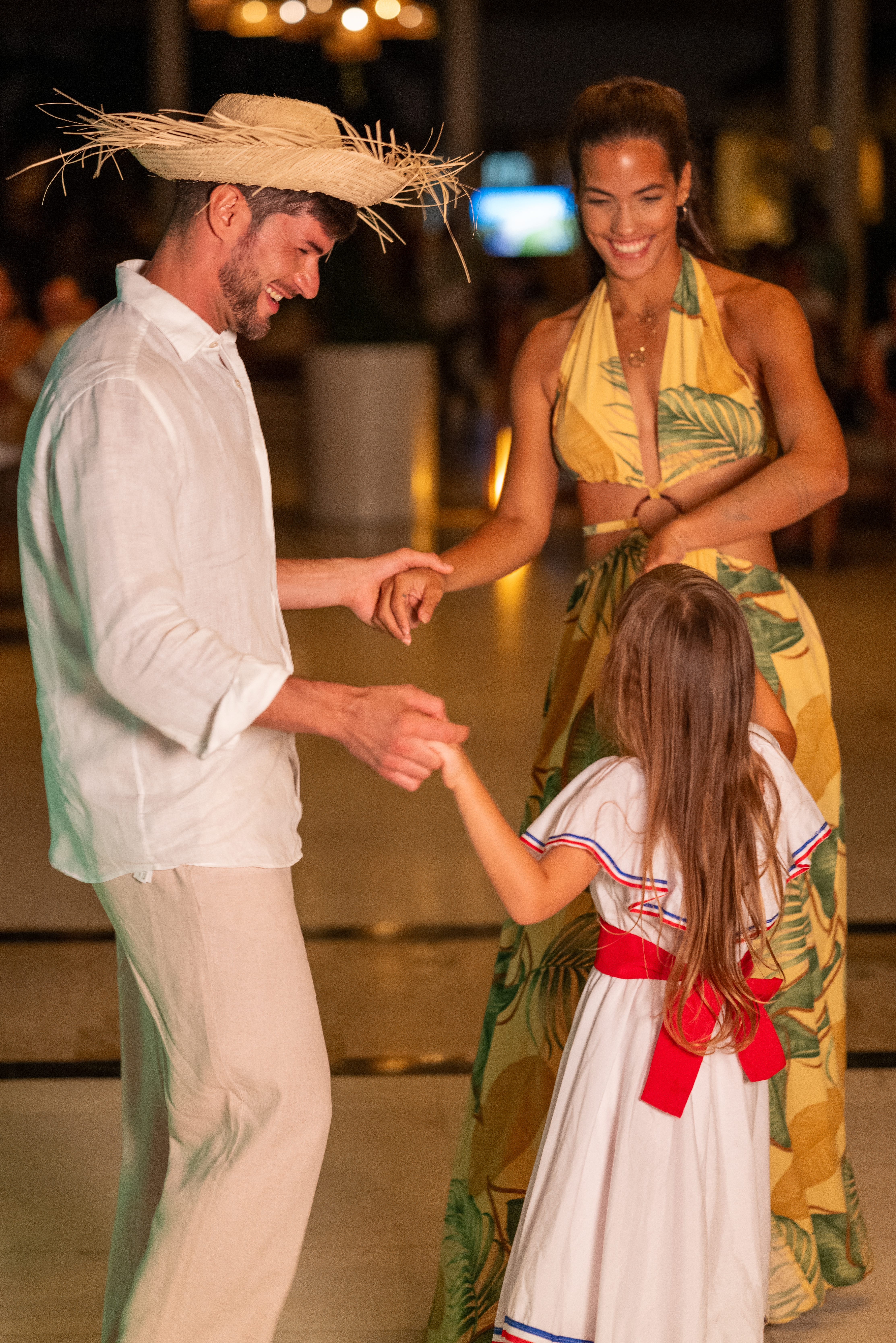 a man and woman holding hands and smiling