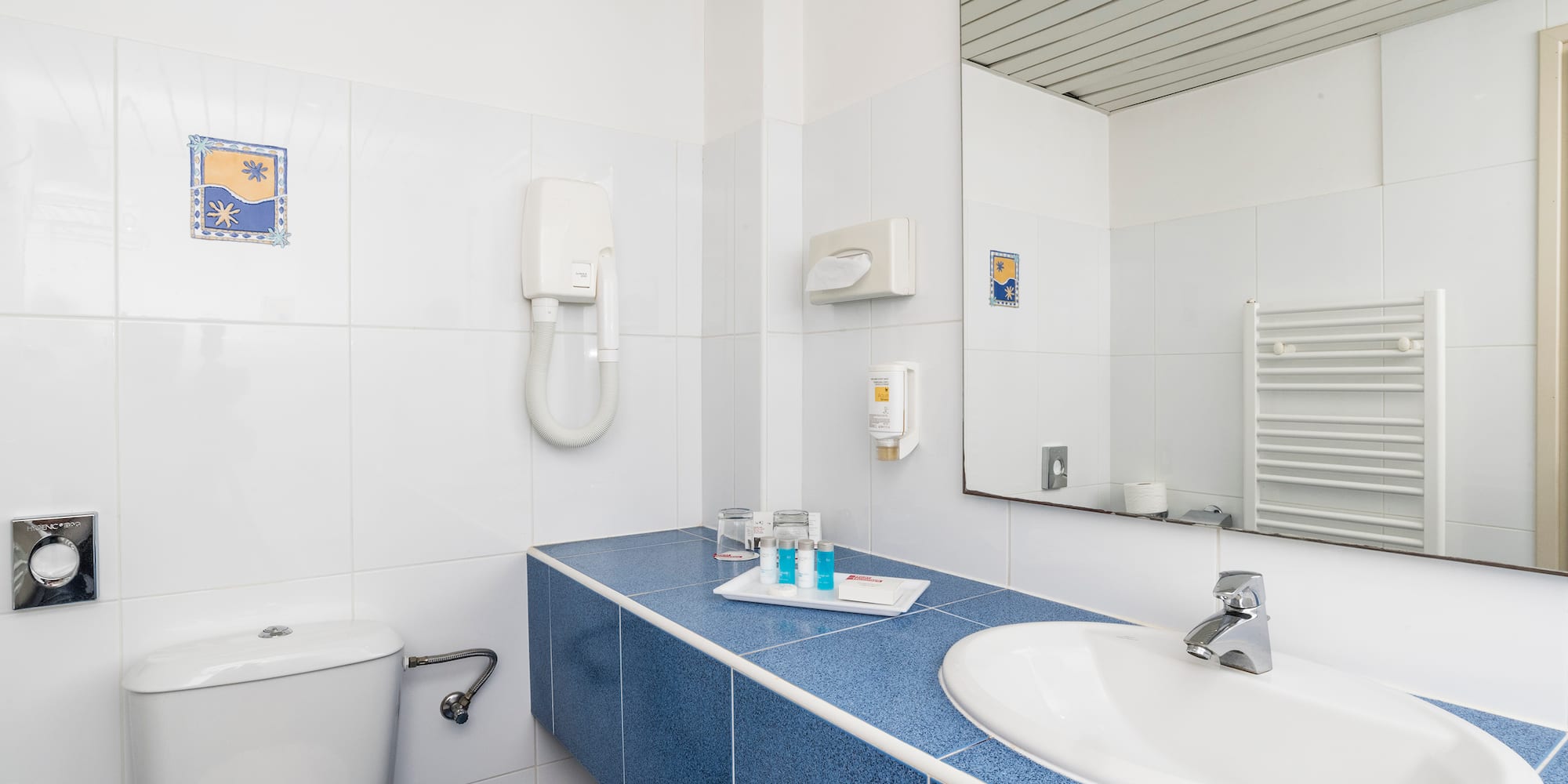 a bathroom with a blue countertop and a toilet