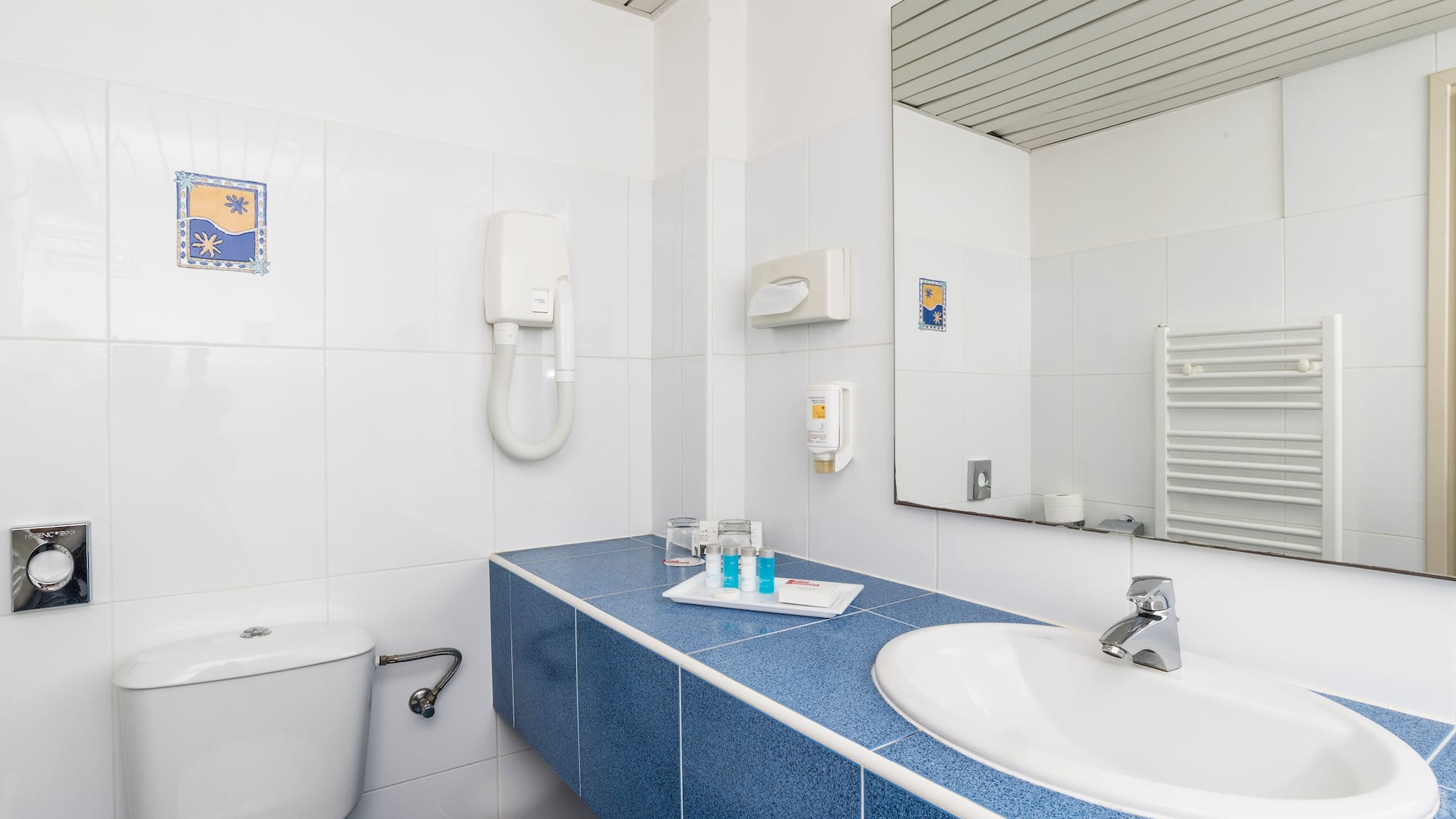 a bathroom with a blue countertop and a toilet