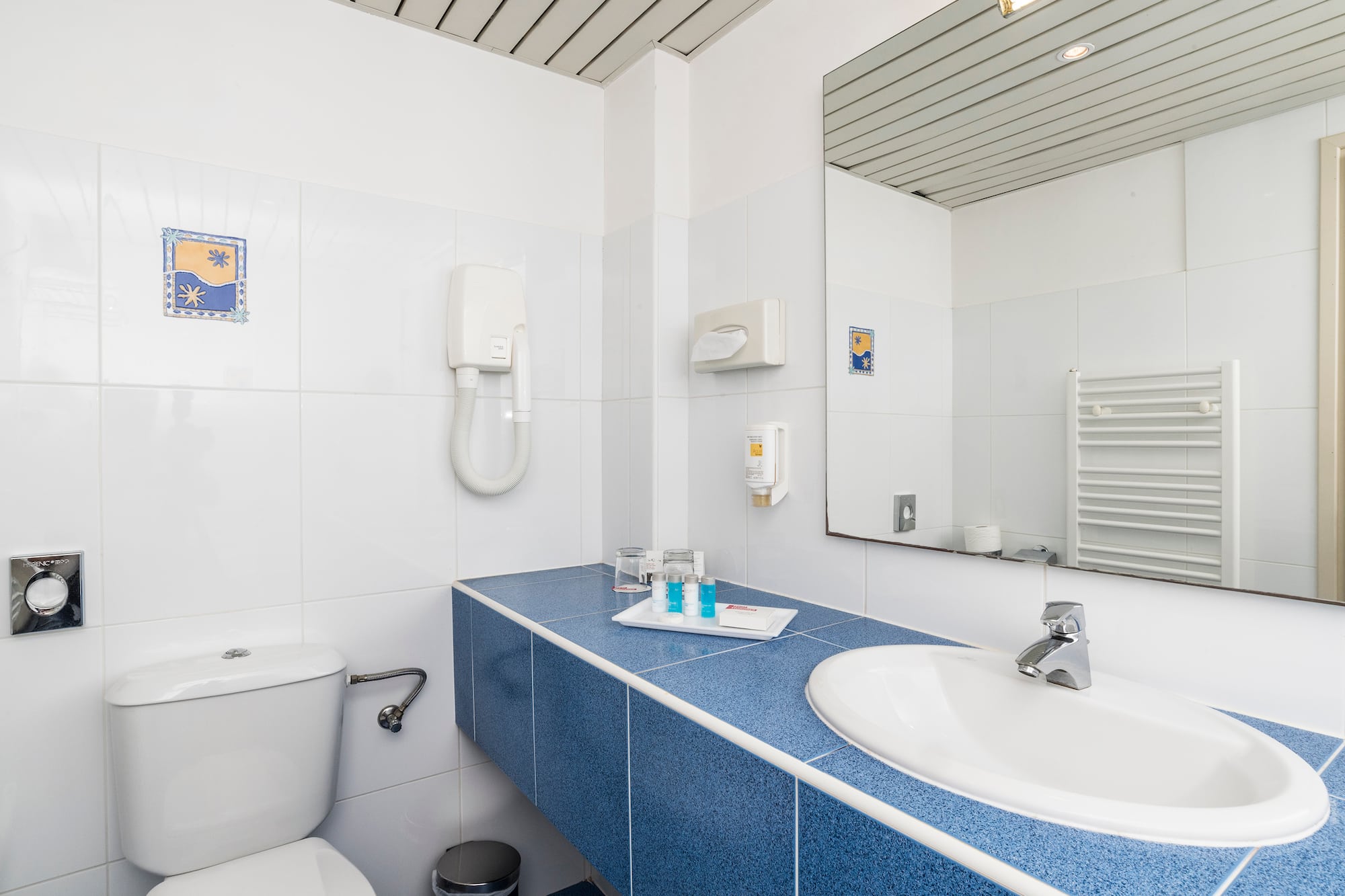 a bathroom with a blue countertop and a toilet