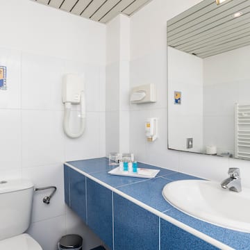 a bathroom with a blue countertop and a toilet