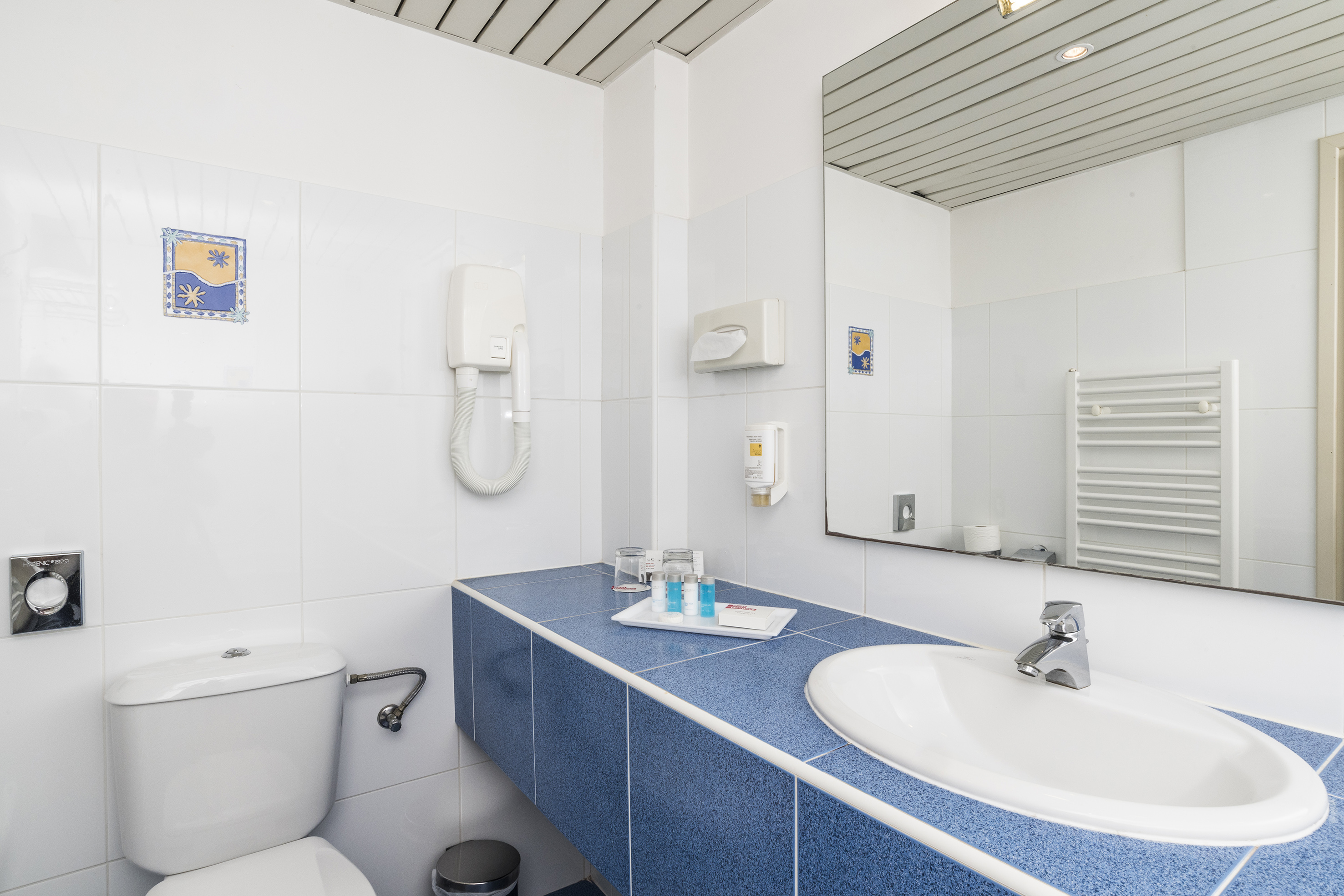 a bathroom with a blue countertop and a toilet