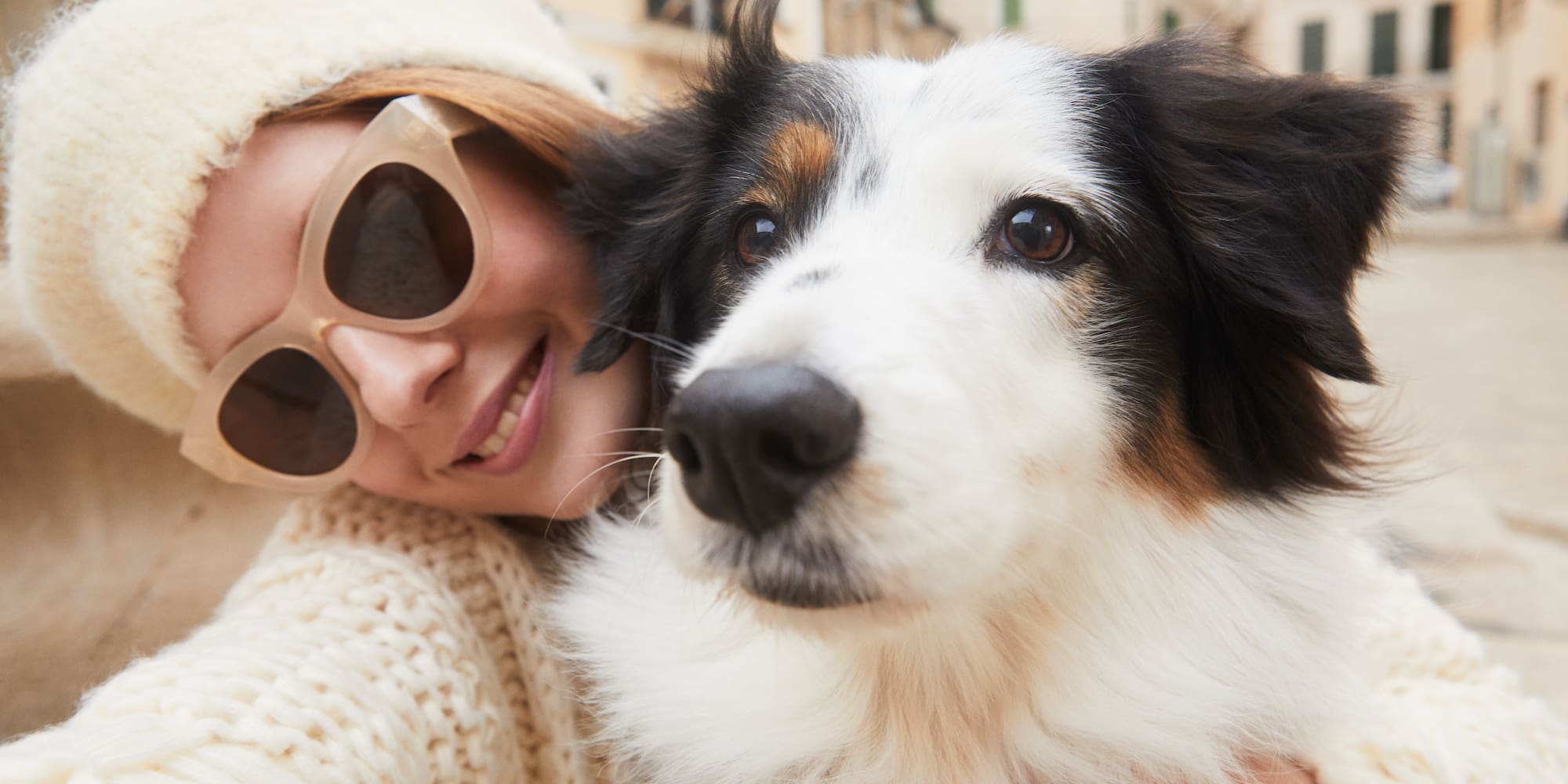 a woman holding a dog