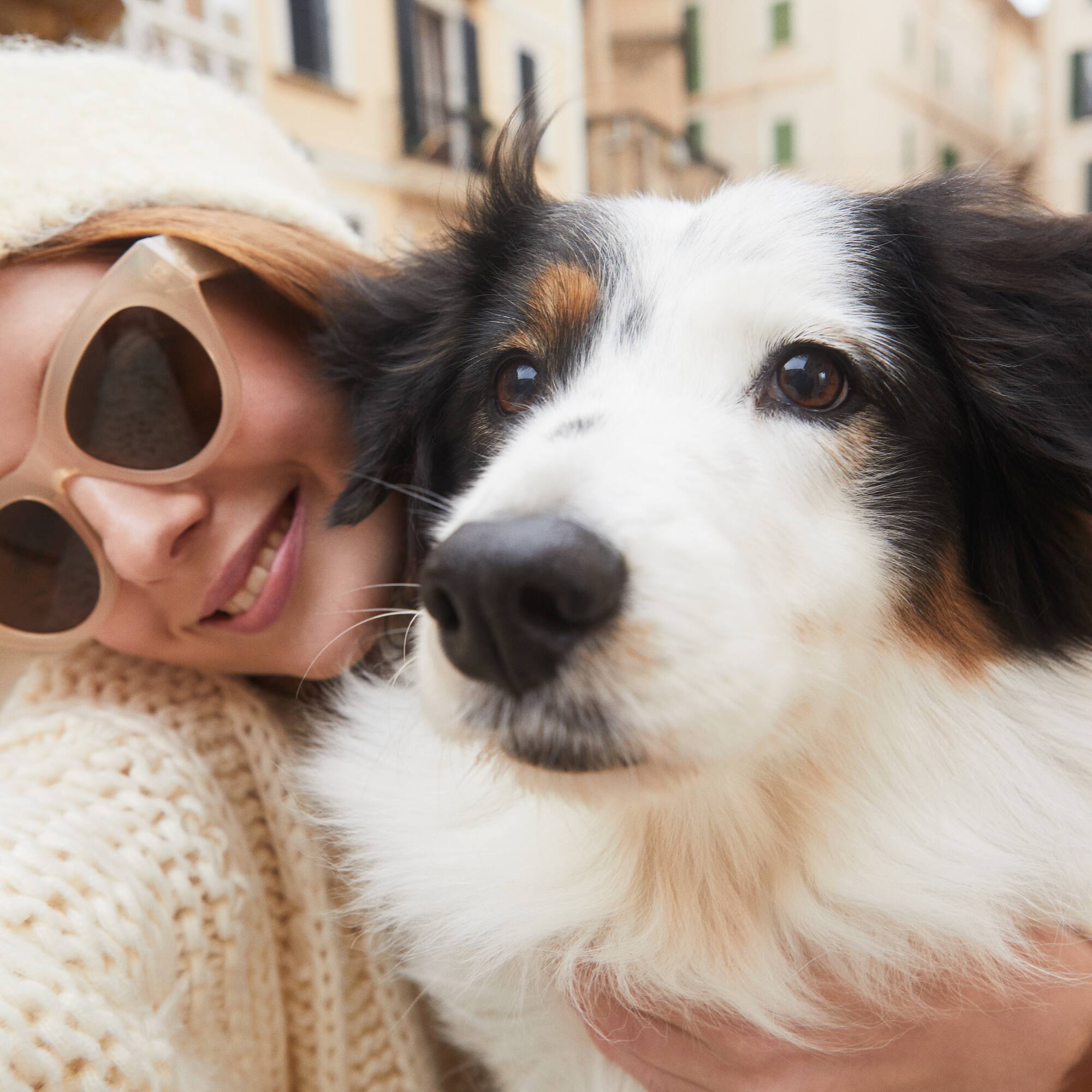 a woman holding a dog