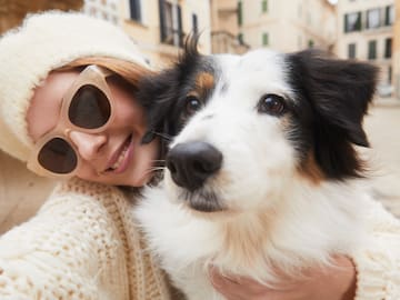 a woman holding a dog