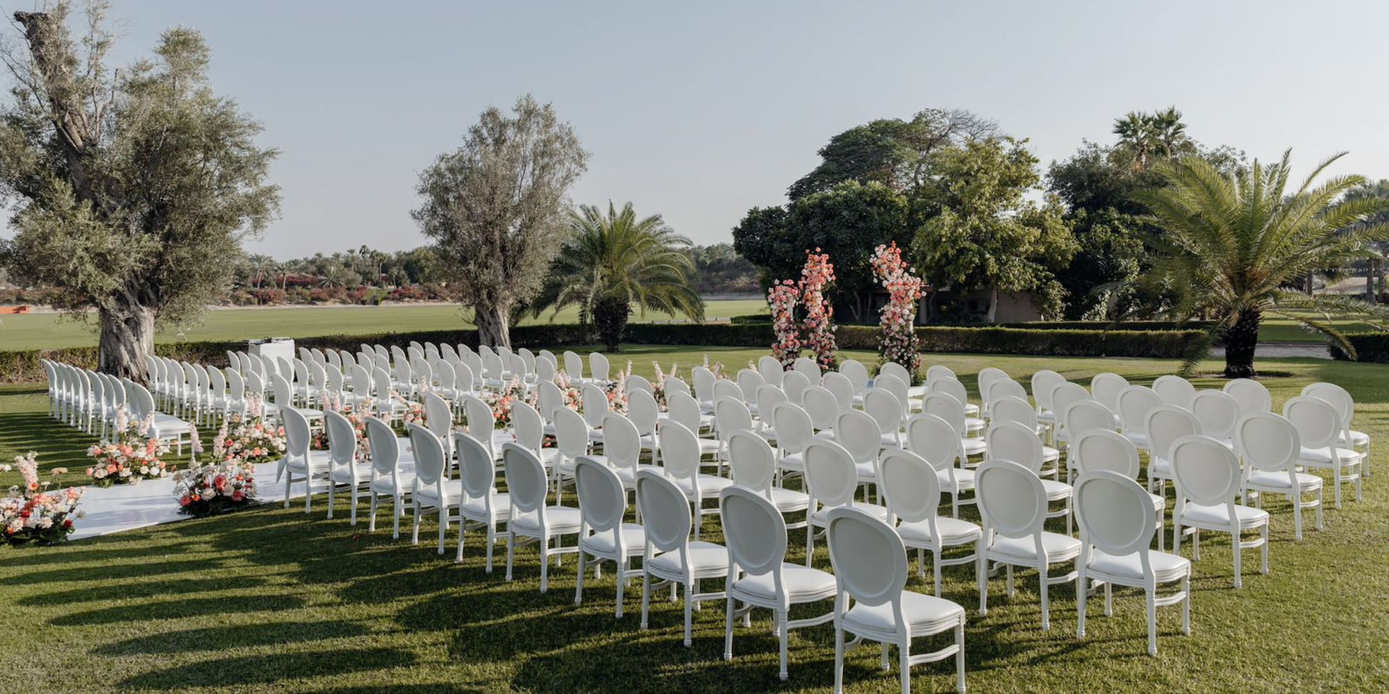 a group of white chairs in a field
