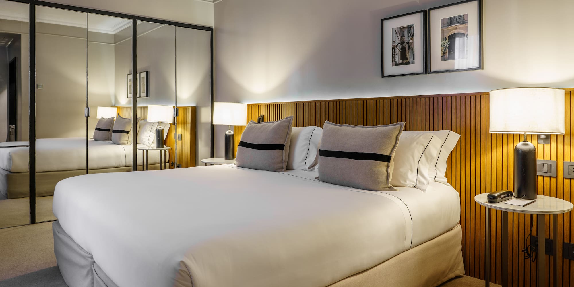 a bed with a mirror and lamps