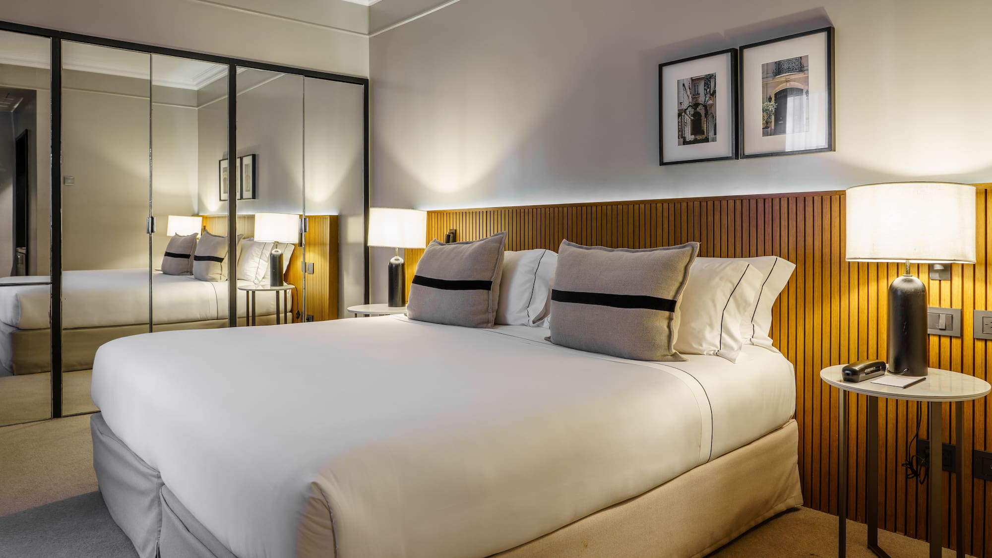 a bed with a mirror and lamps