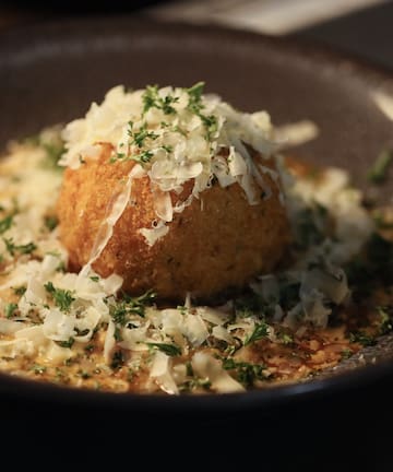 a bowl of food with grated cheese