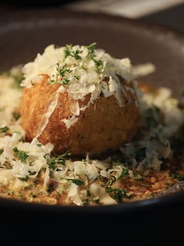 a bowl of food with grated cheese