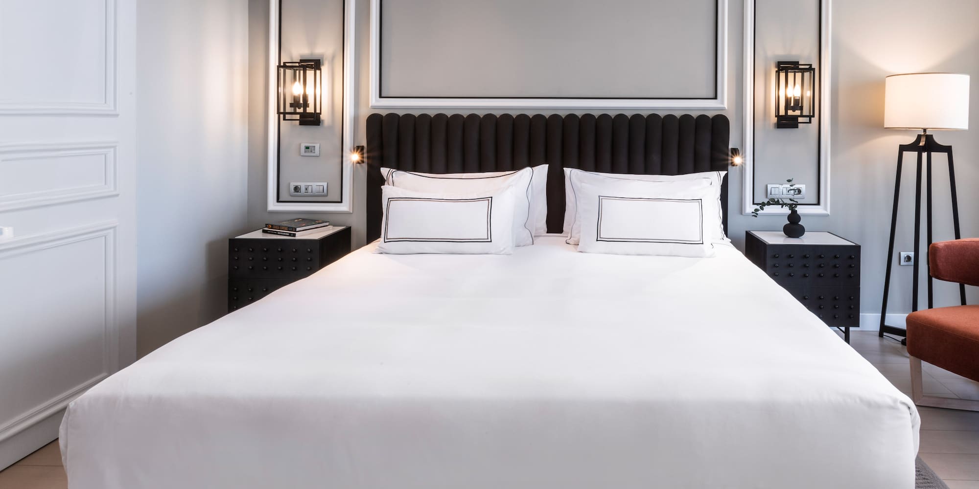 a bed with white sheets and pillows