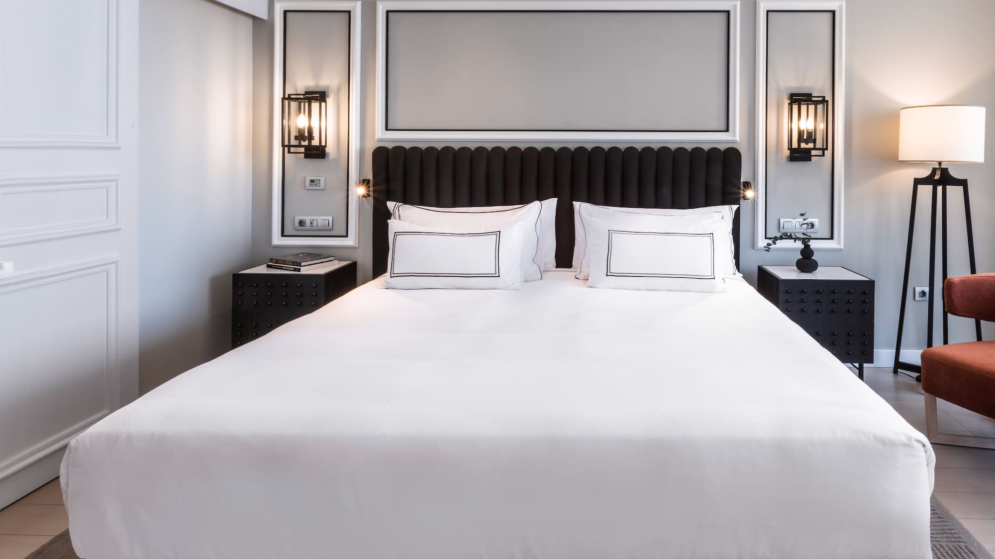 a bed with white sheets and pillows