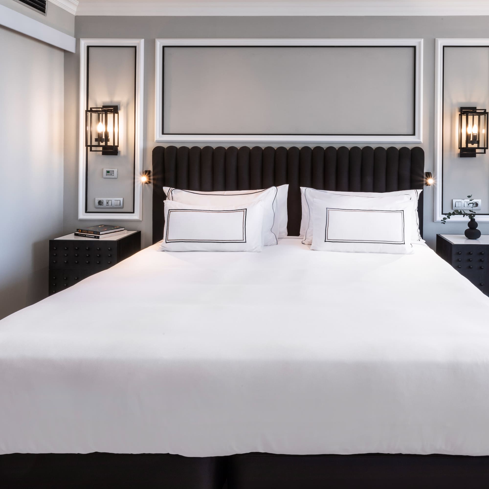 a bed with white sheets and pillows