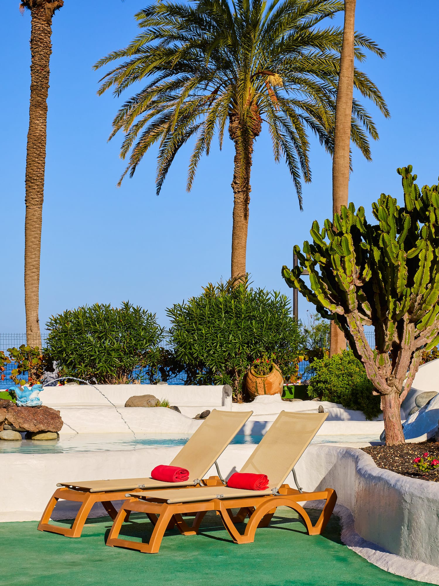 a lounge chairs by a pool