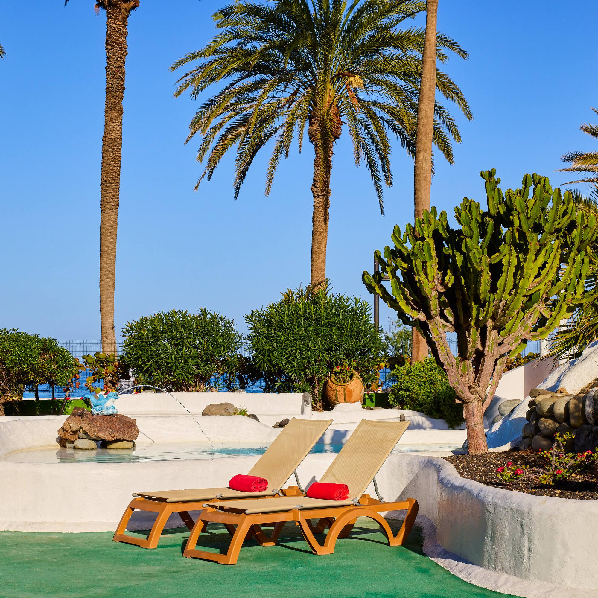 a lounge chairs by a pool