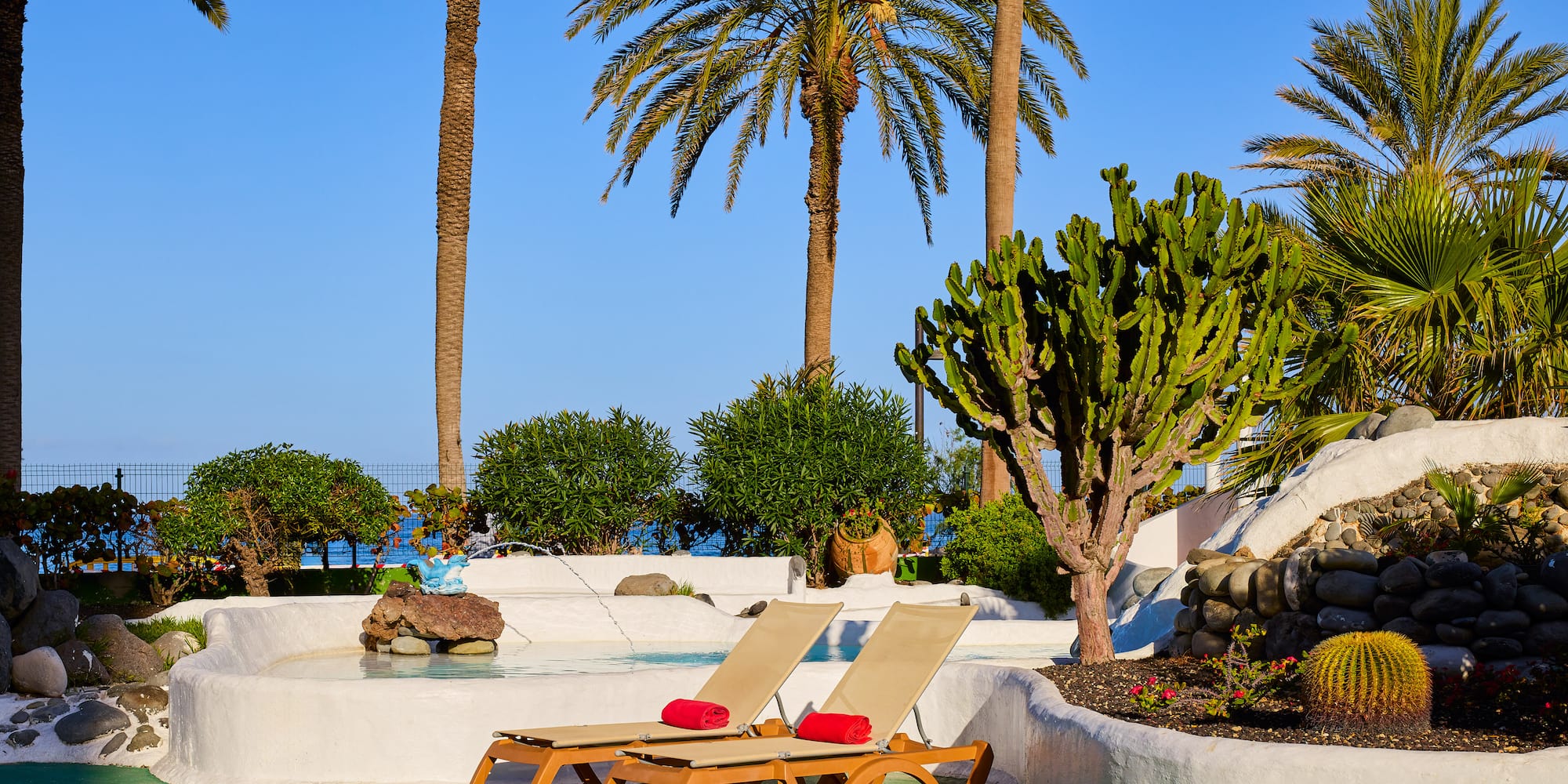 a lounge chairs by a pool