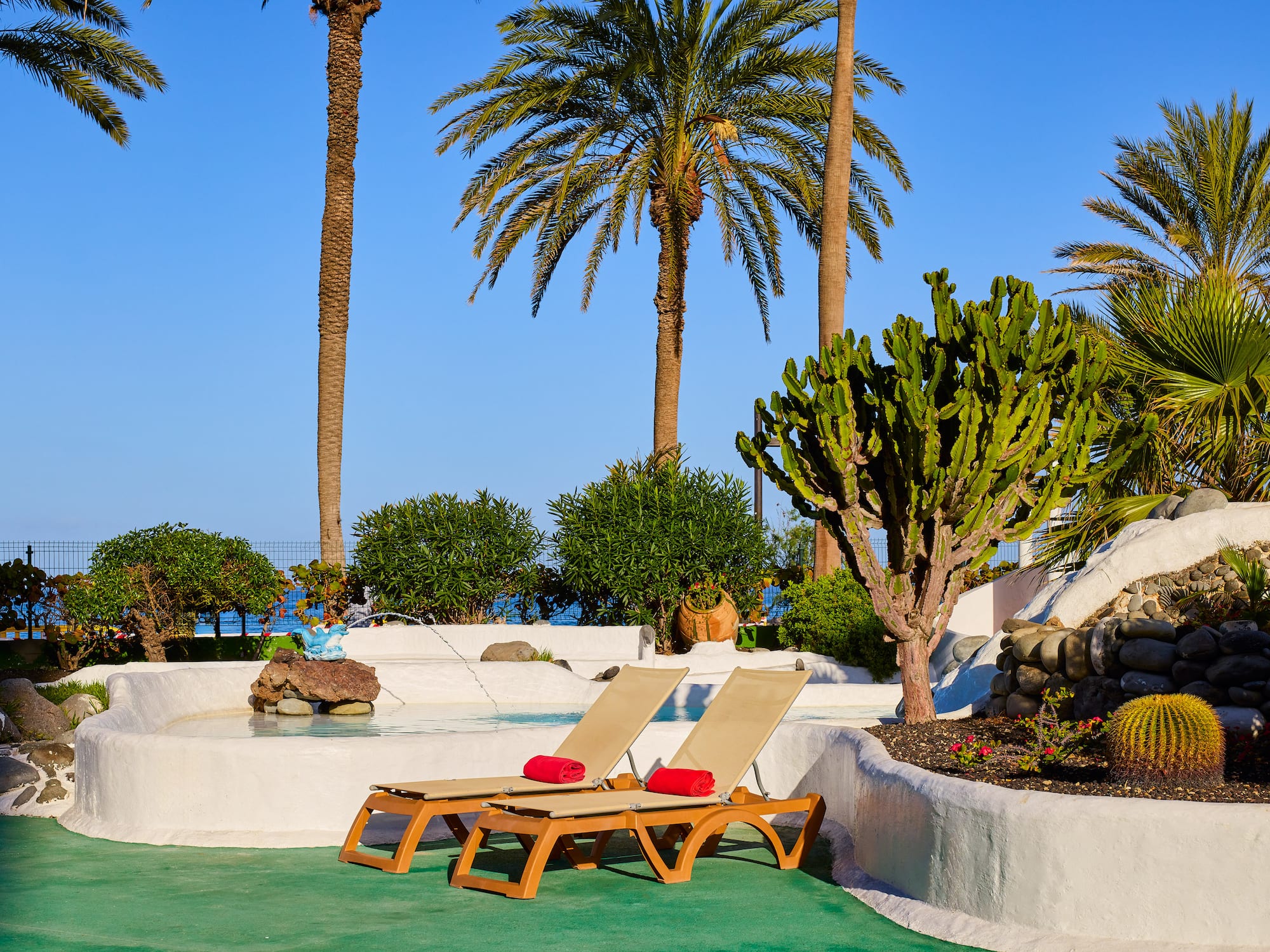 a lounge chairs by a pool