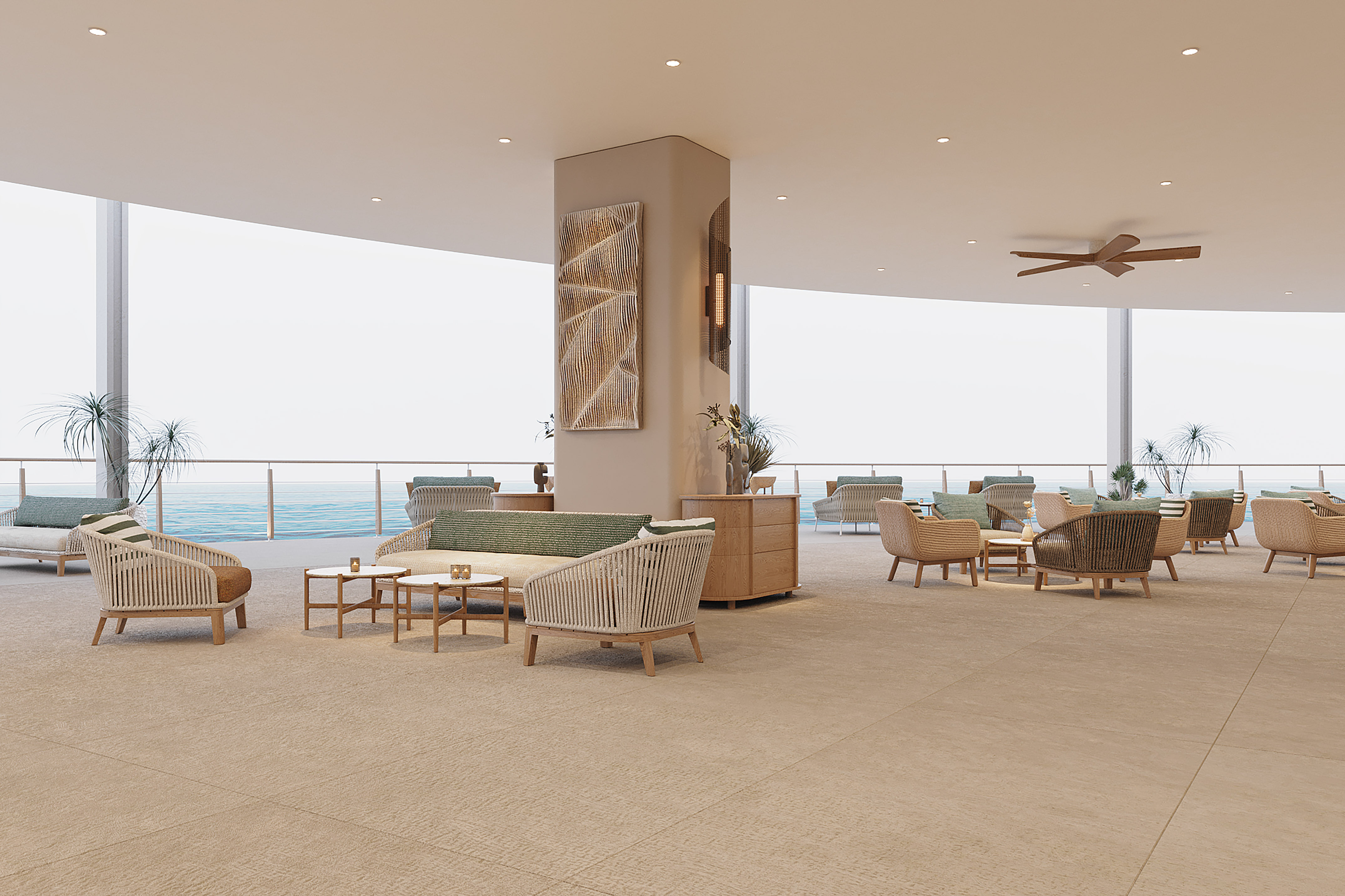 Hotel lounge with modern coastal furniture overlooking the ocean.