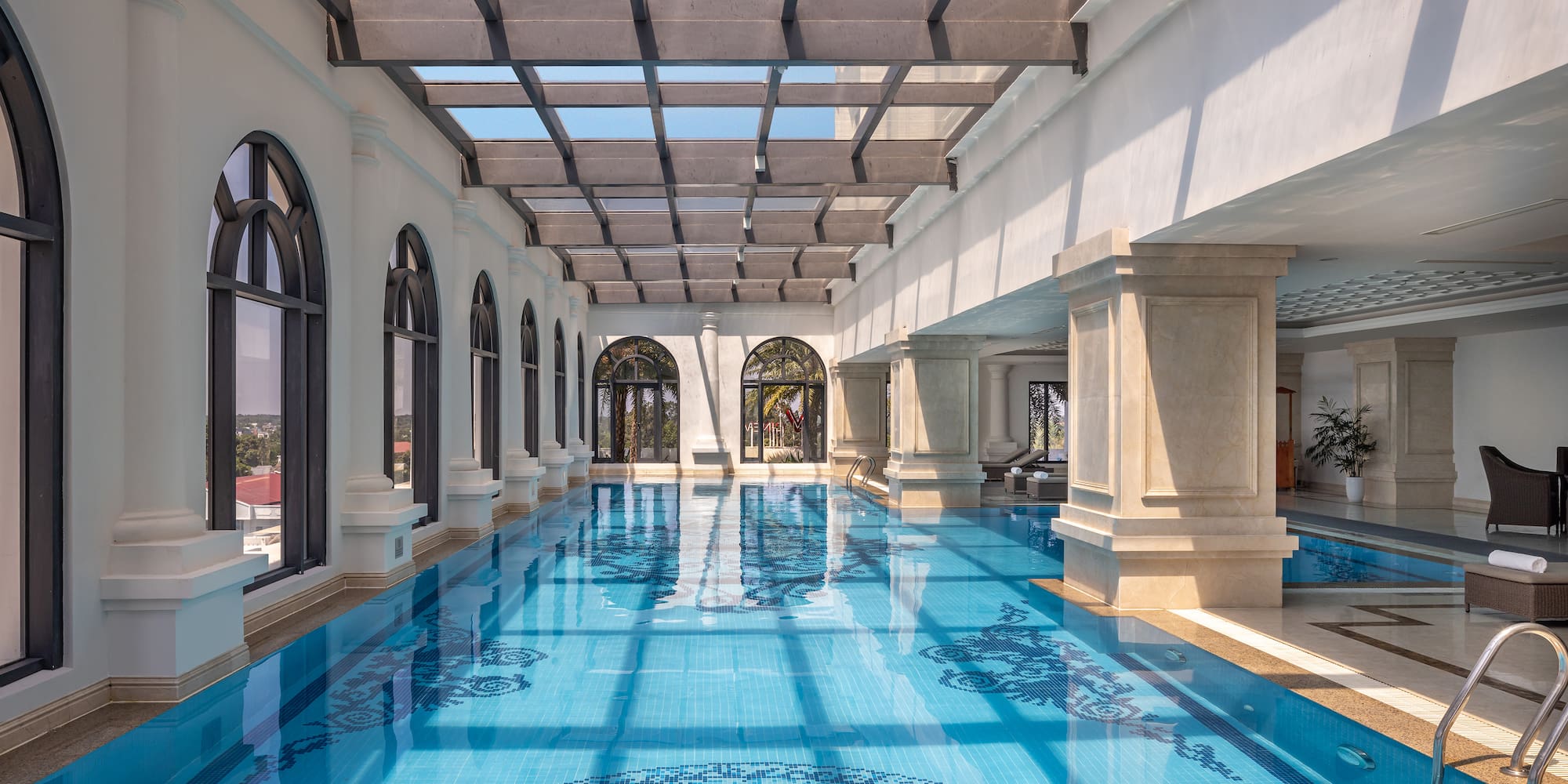 a indoor swimming pool with a glass roof