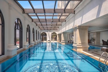 a indoor swimming pool with a glass roof