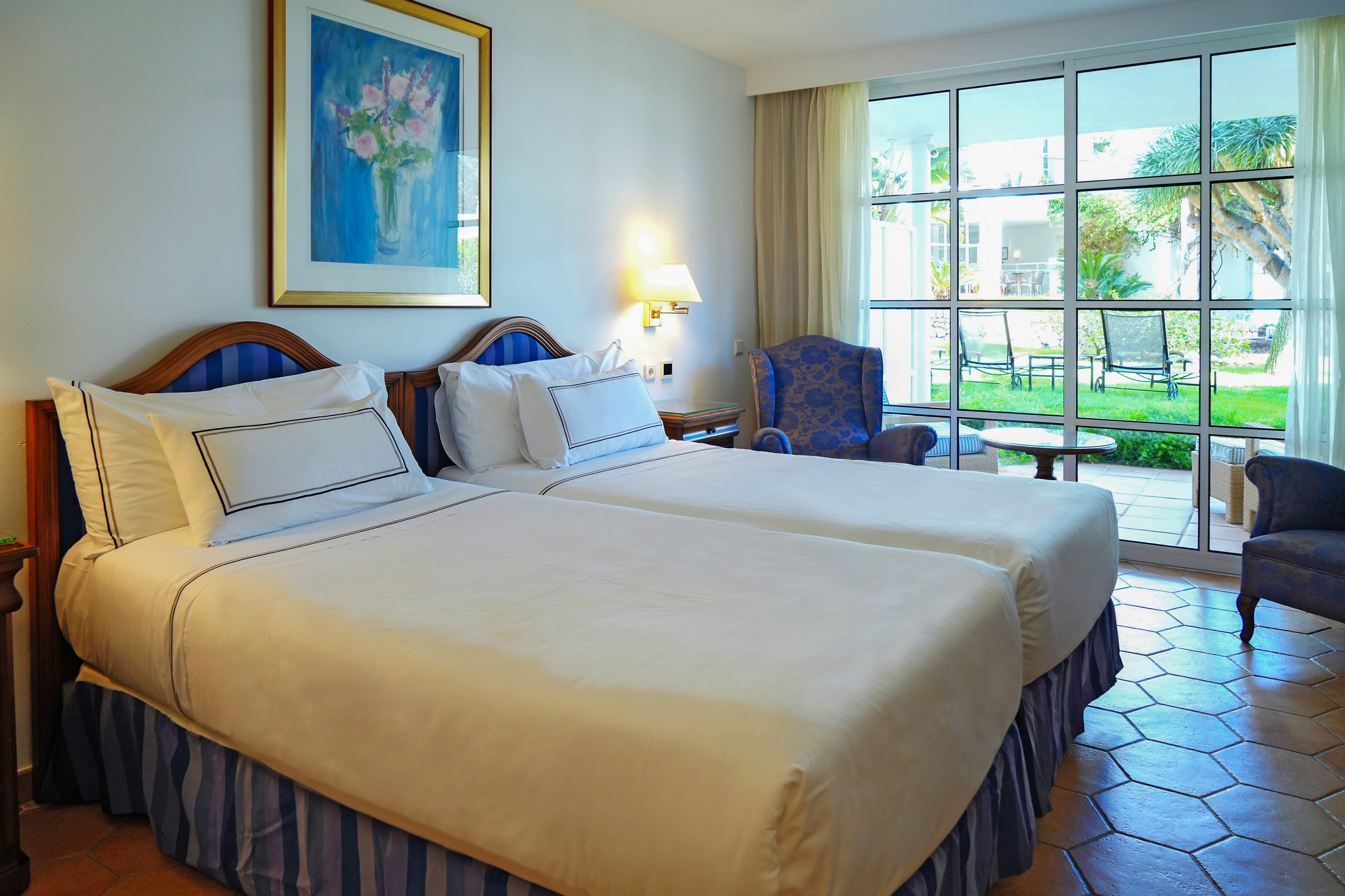 a room with two beds and a chair