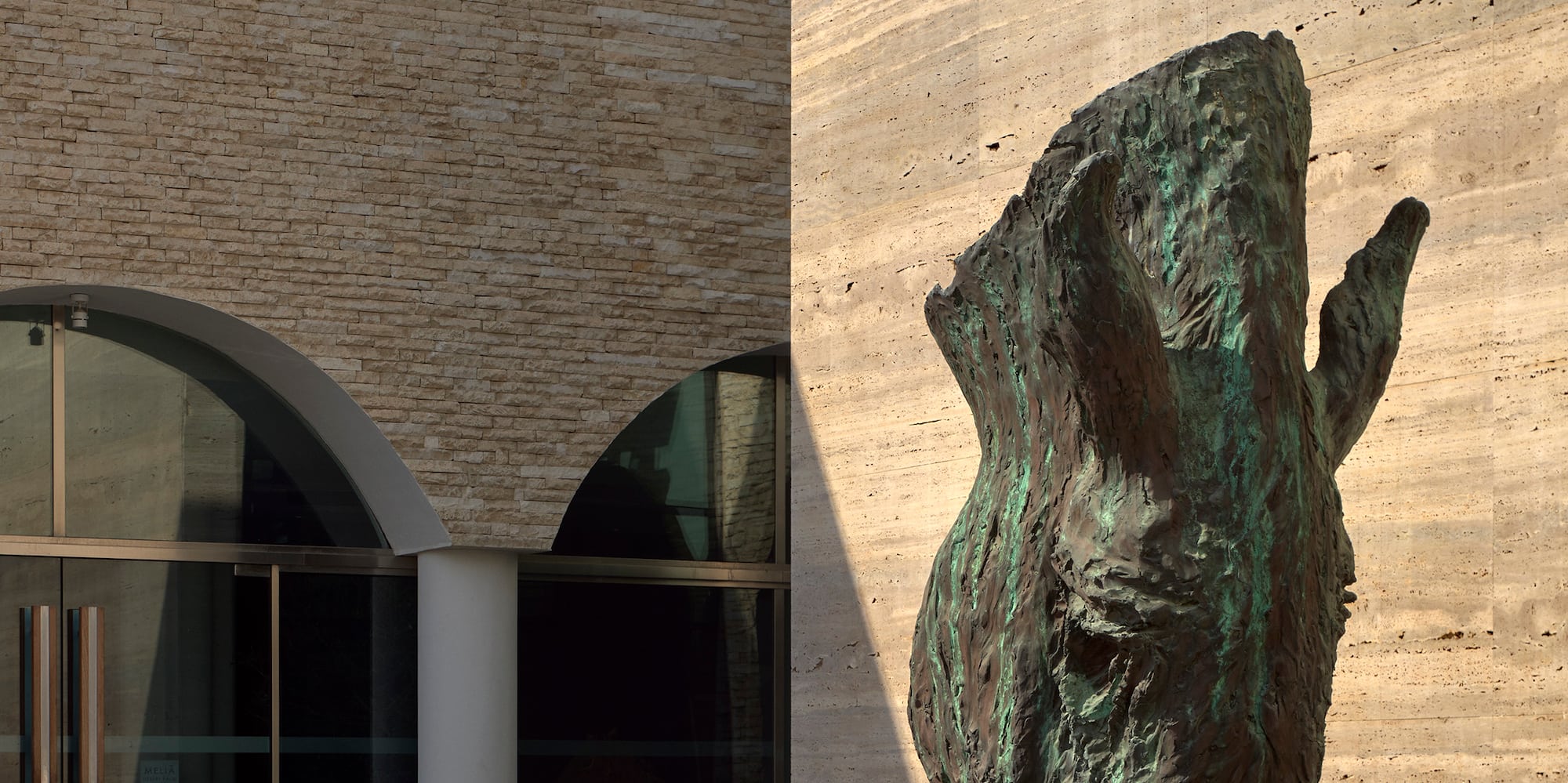 a statue of a horse head in front of a building