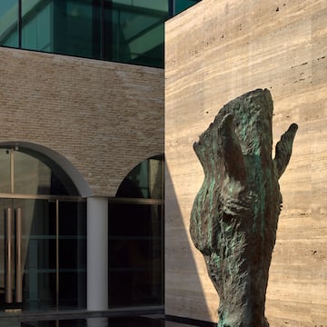 a statue of a horse head in front of a building