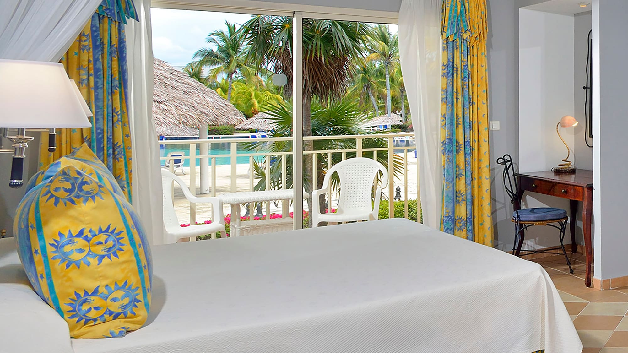 a room with a bed and a table and chairs