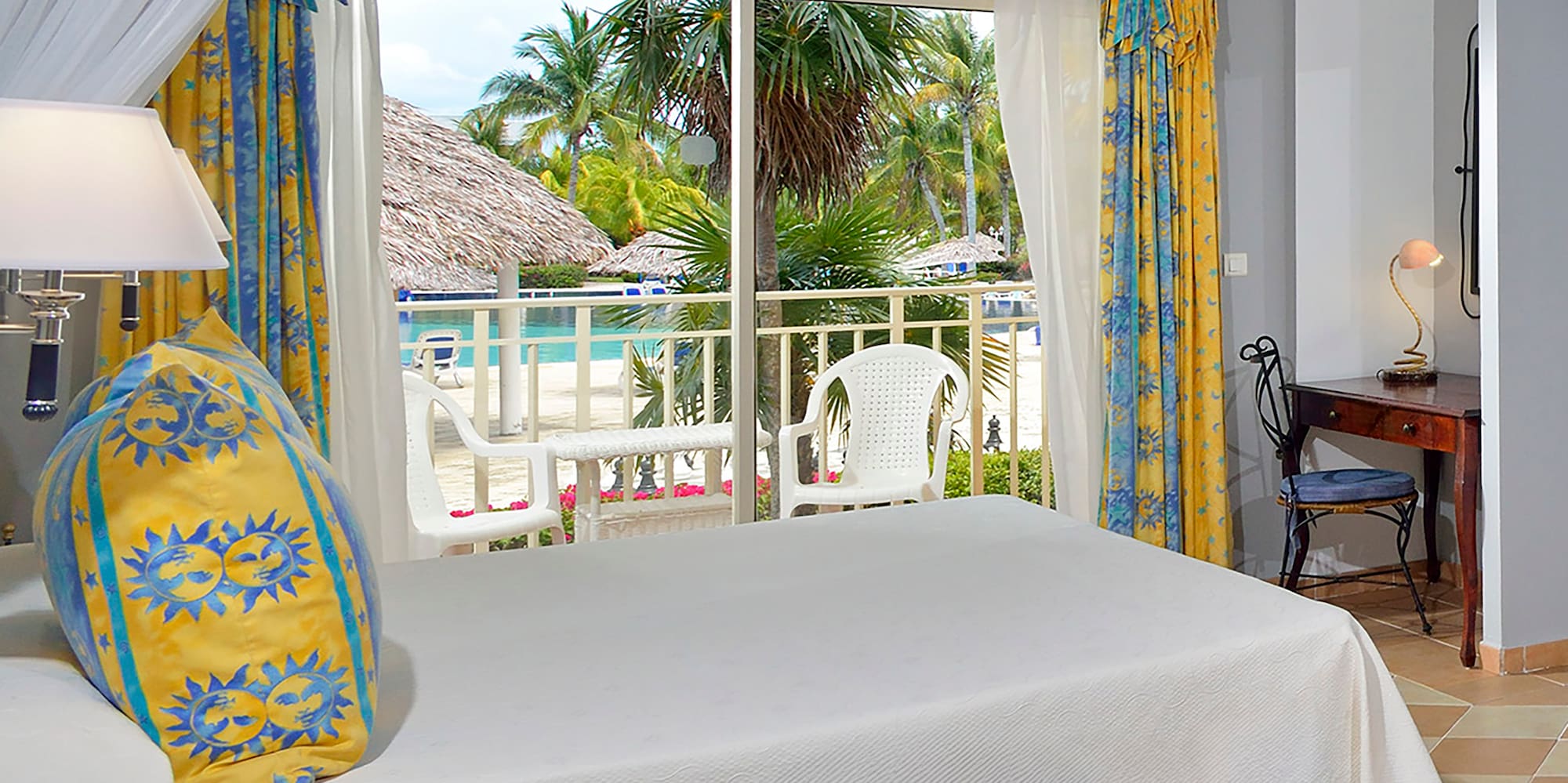 a room with a bed and a table and chairs