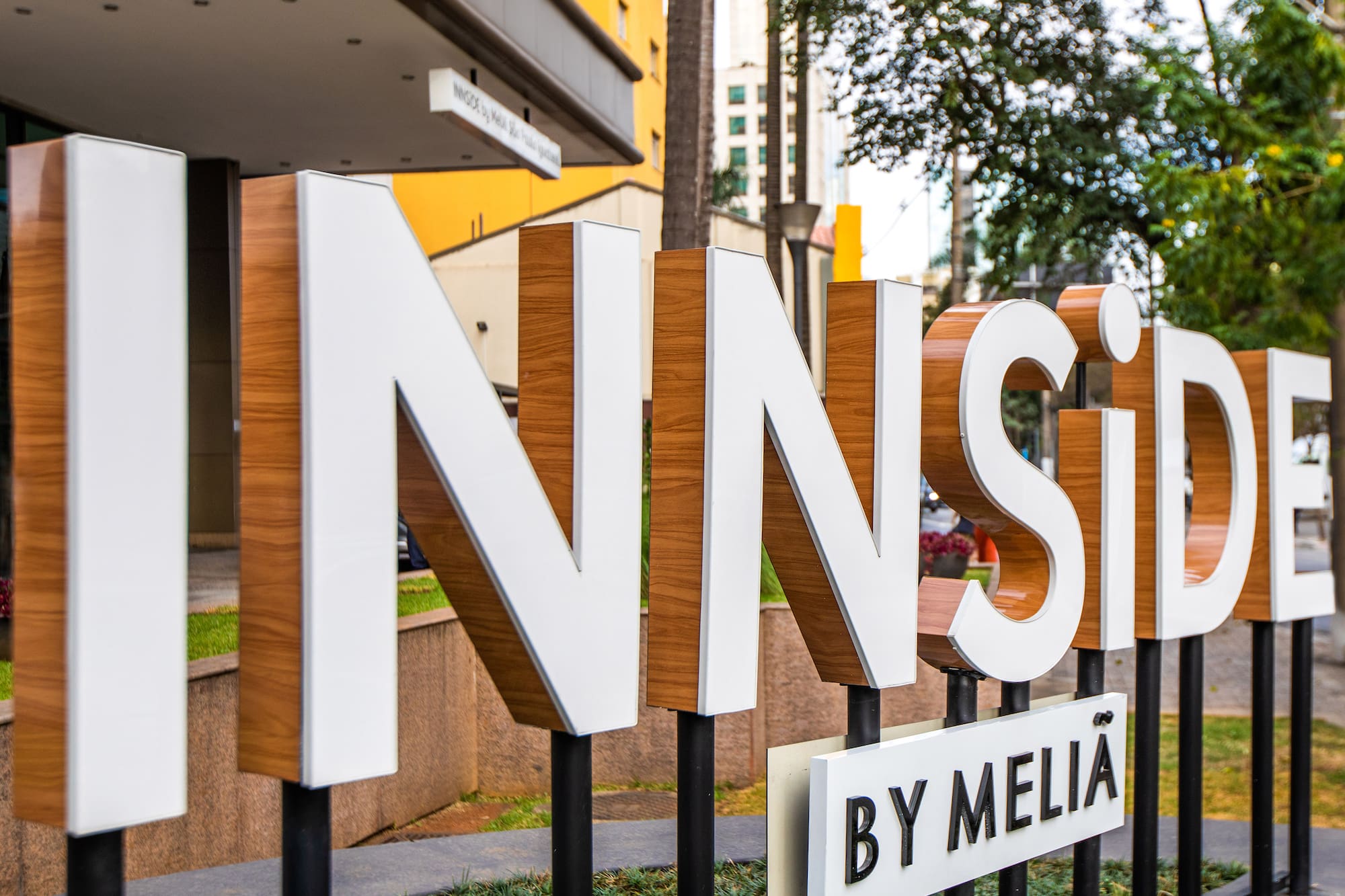 INNSiDE BY MELIÃ hotel sign with white and wood-grain letters at entrance.