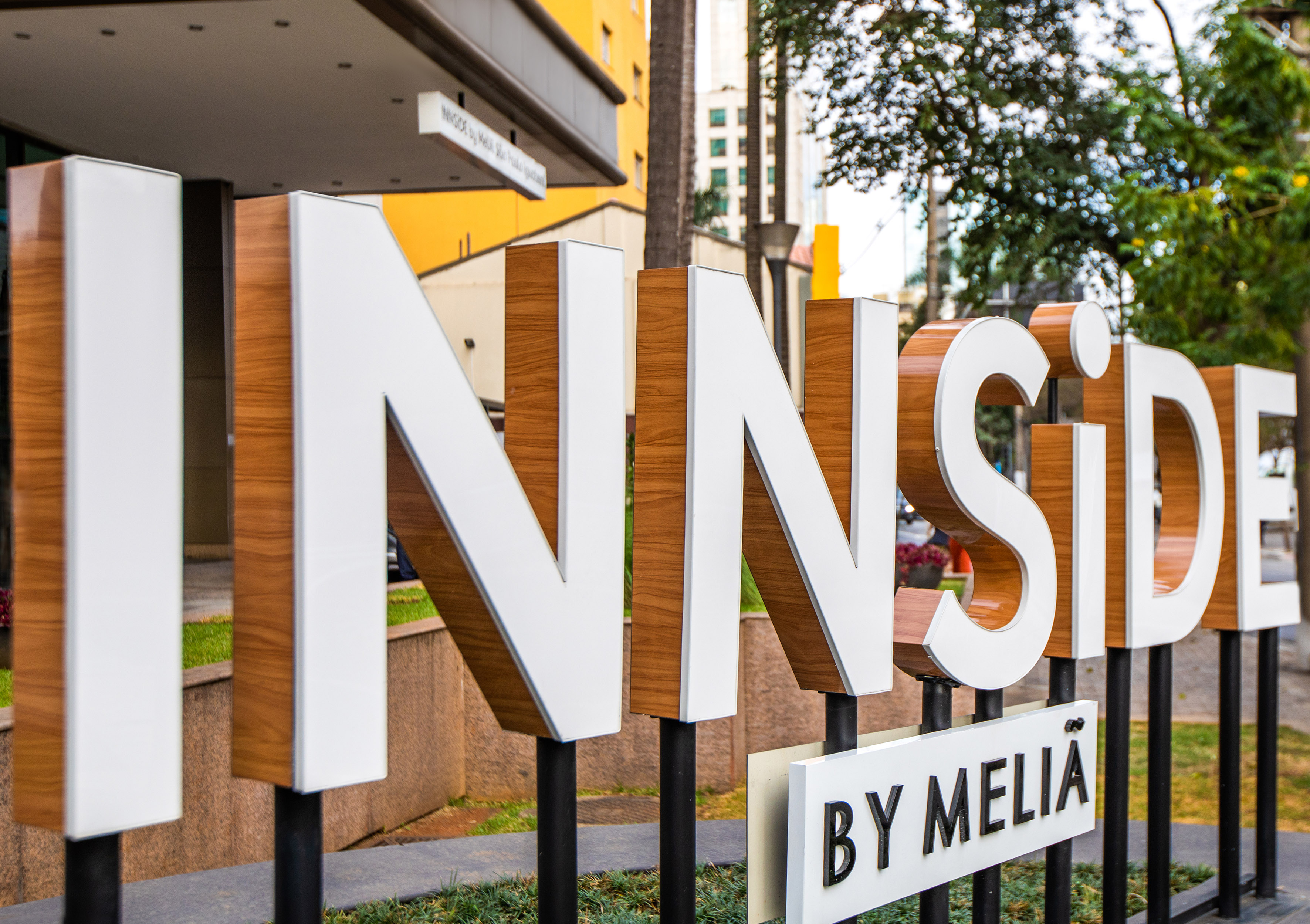 INNSiDE BY MELIÃ hotel sign with white and wood-grain letters at entrance.