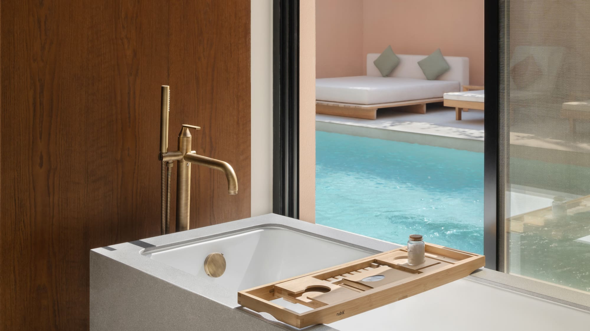 a bathtub with a pool outside