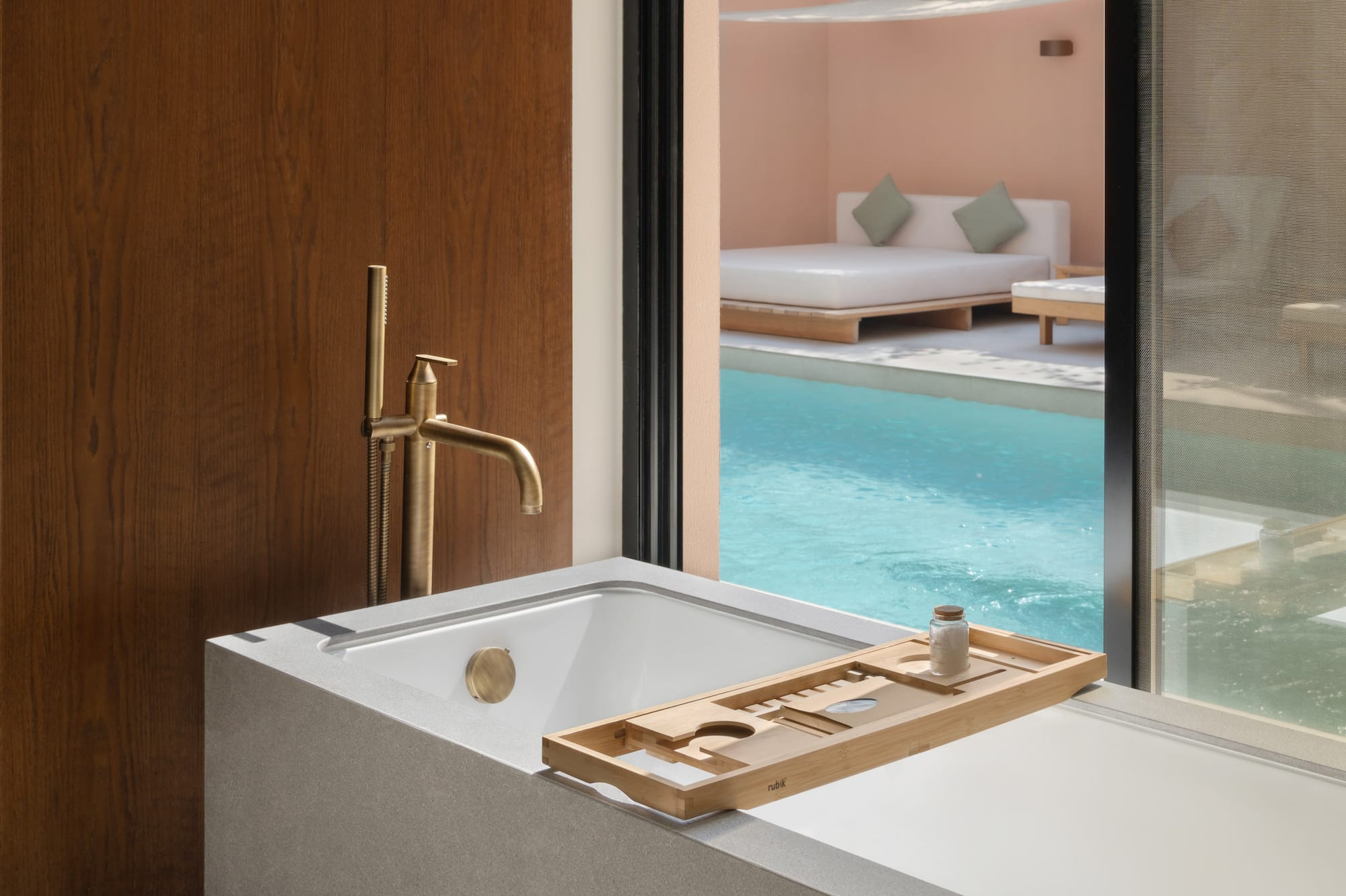 a bathtub with a pool outside