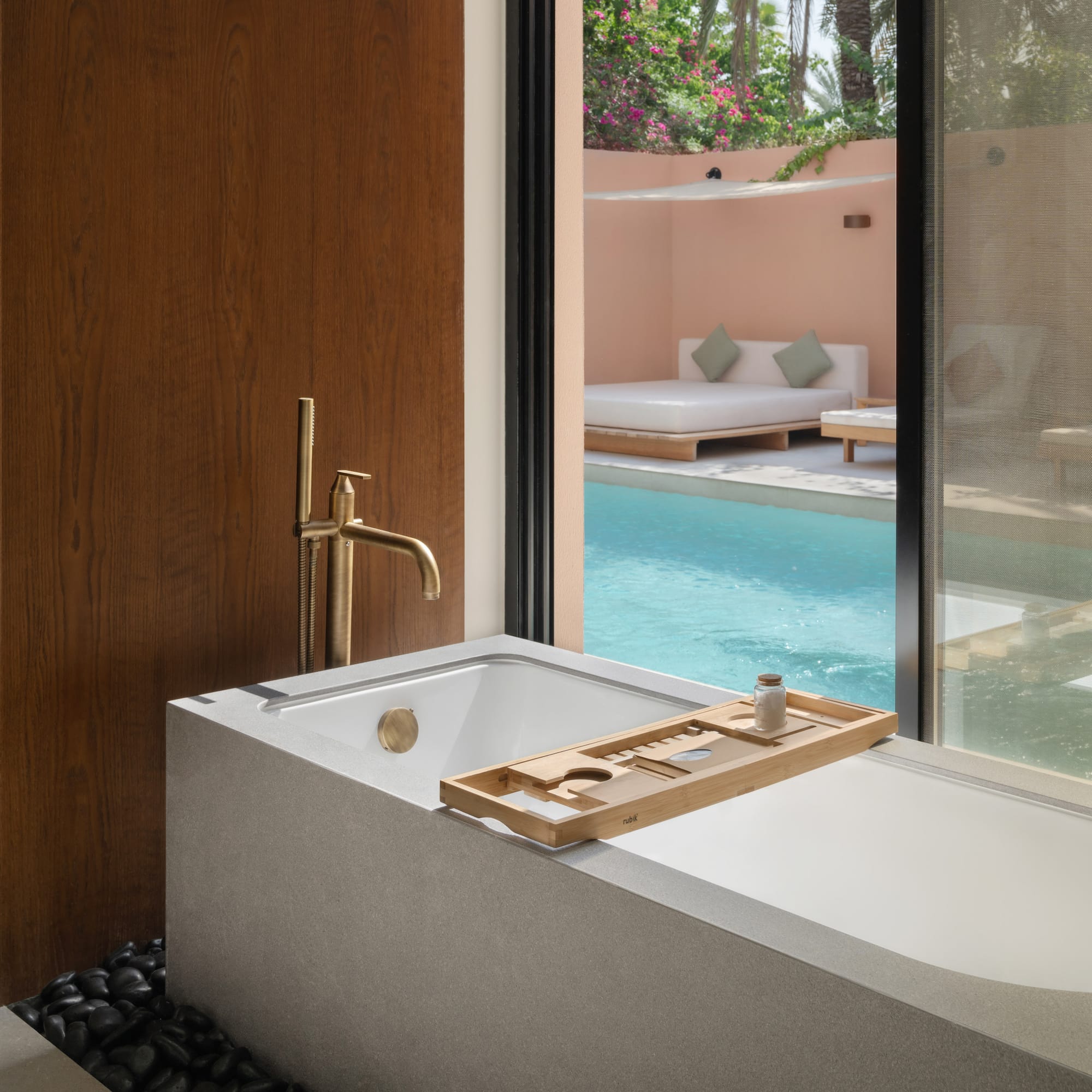 a bathtub with a pool outside