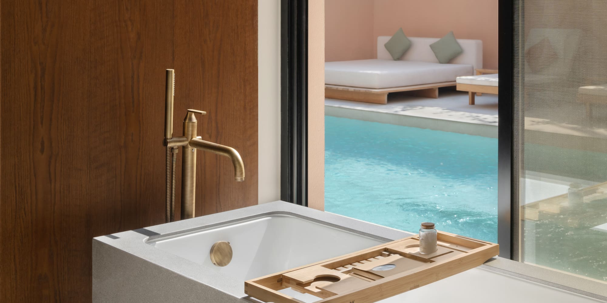 a bathtub with a pool outside