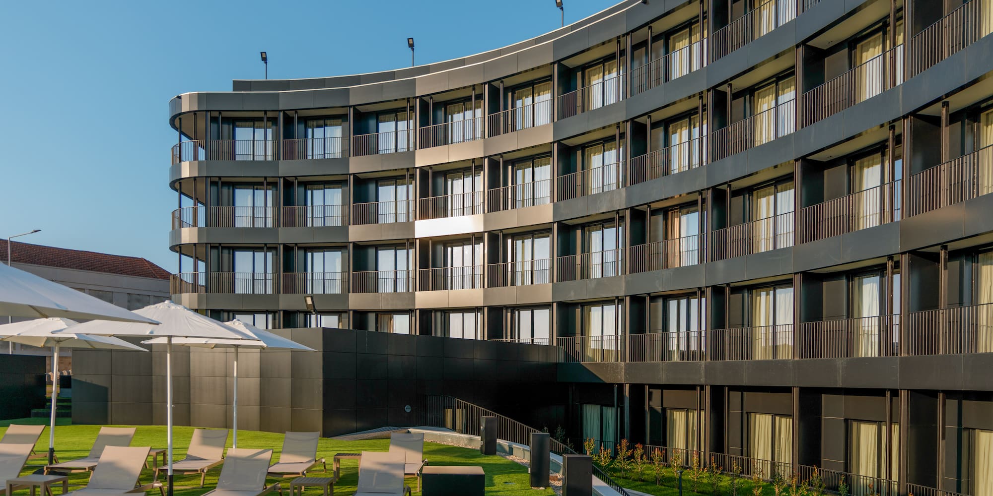 a building with a lawn and chairs