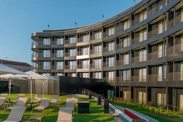 a building with a lawn and chairs