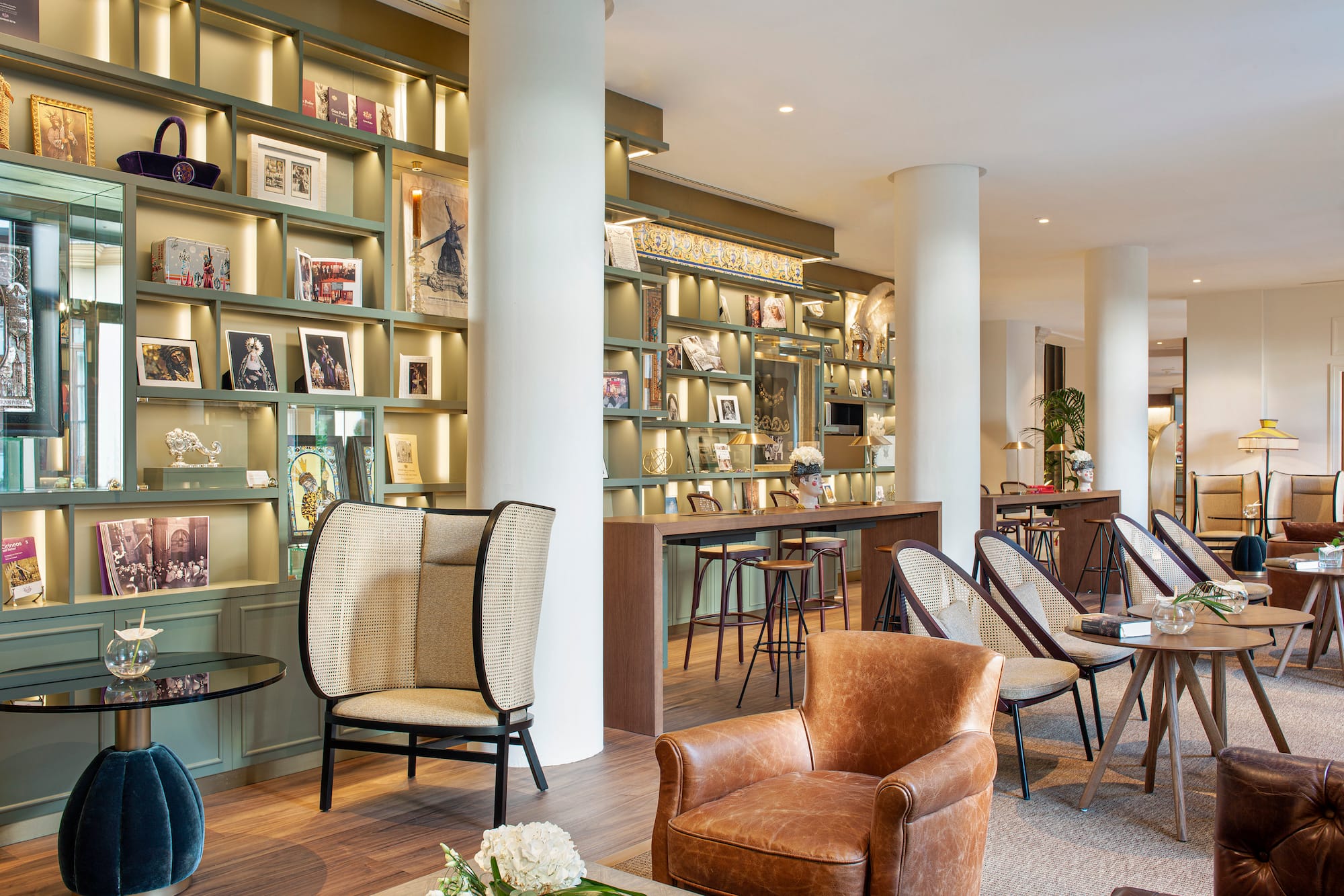 a room with a large white column and chairs