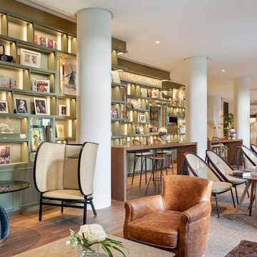 a room with a large white column and chairs