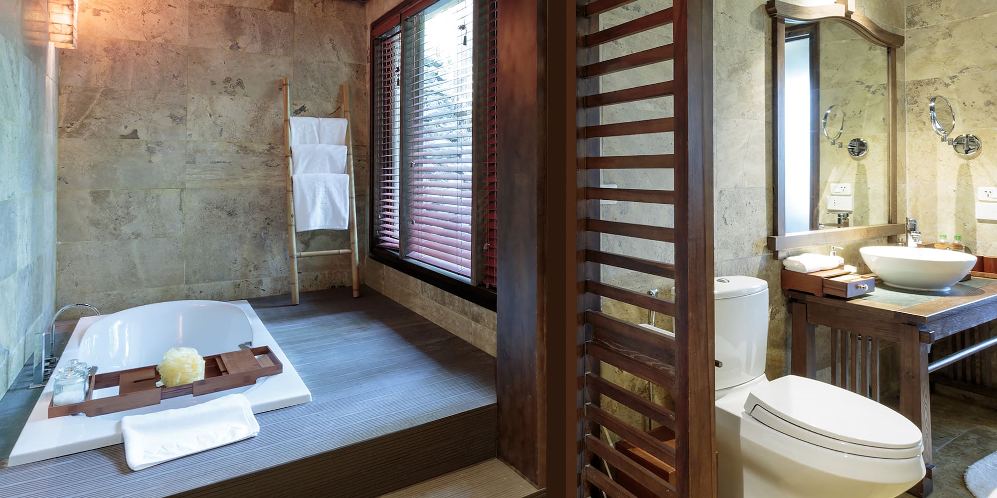 a bathroom with a tub and a toilet